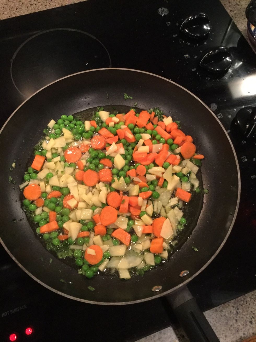 Place peas, carrots, potato in the skillet. Season with salt.