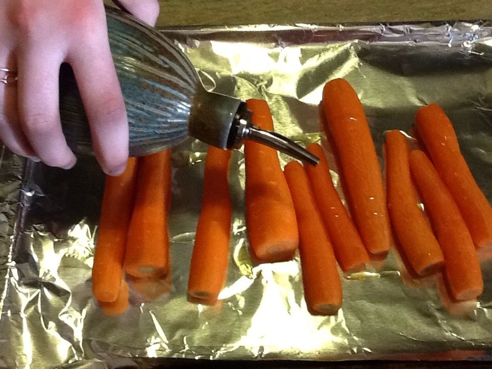 Place peeled carrots on pan and drizzle with olive oil