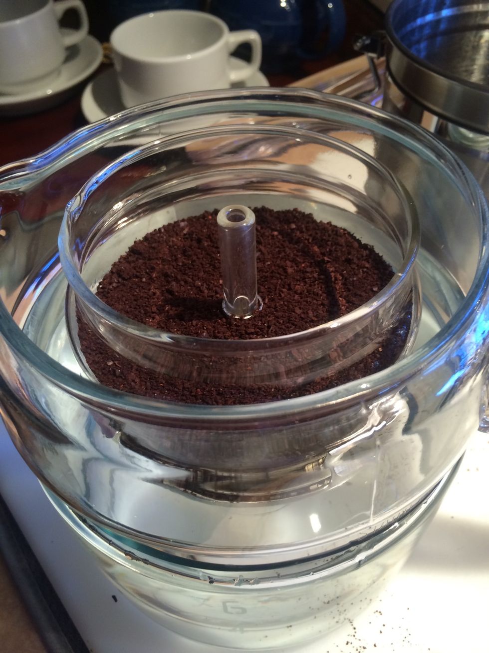 Place percolator brew basket into pot.