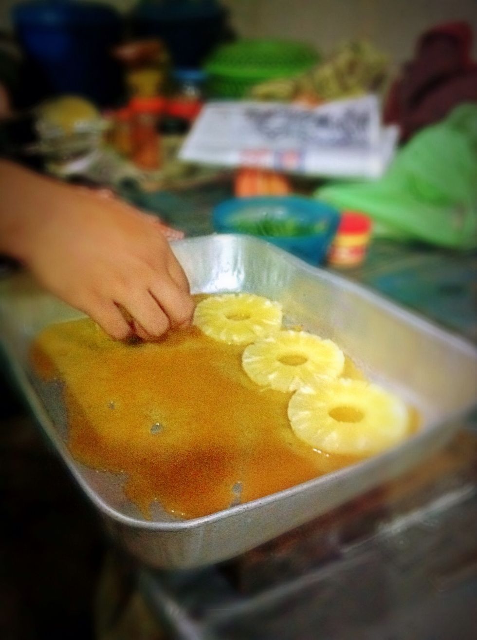 Place pineapple slices around the bake tray.you can arrange them in a nice design if you want.
