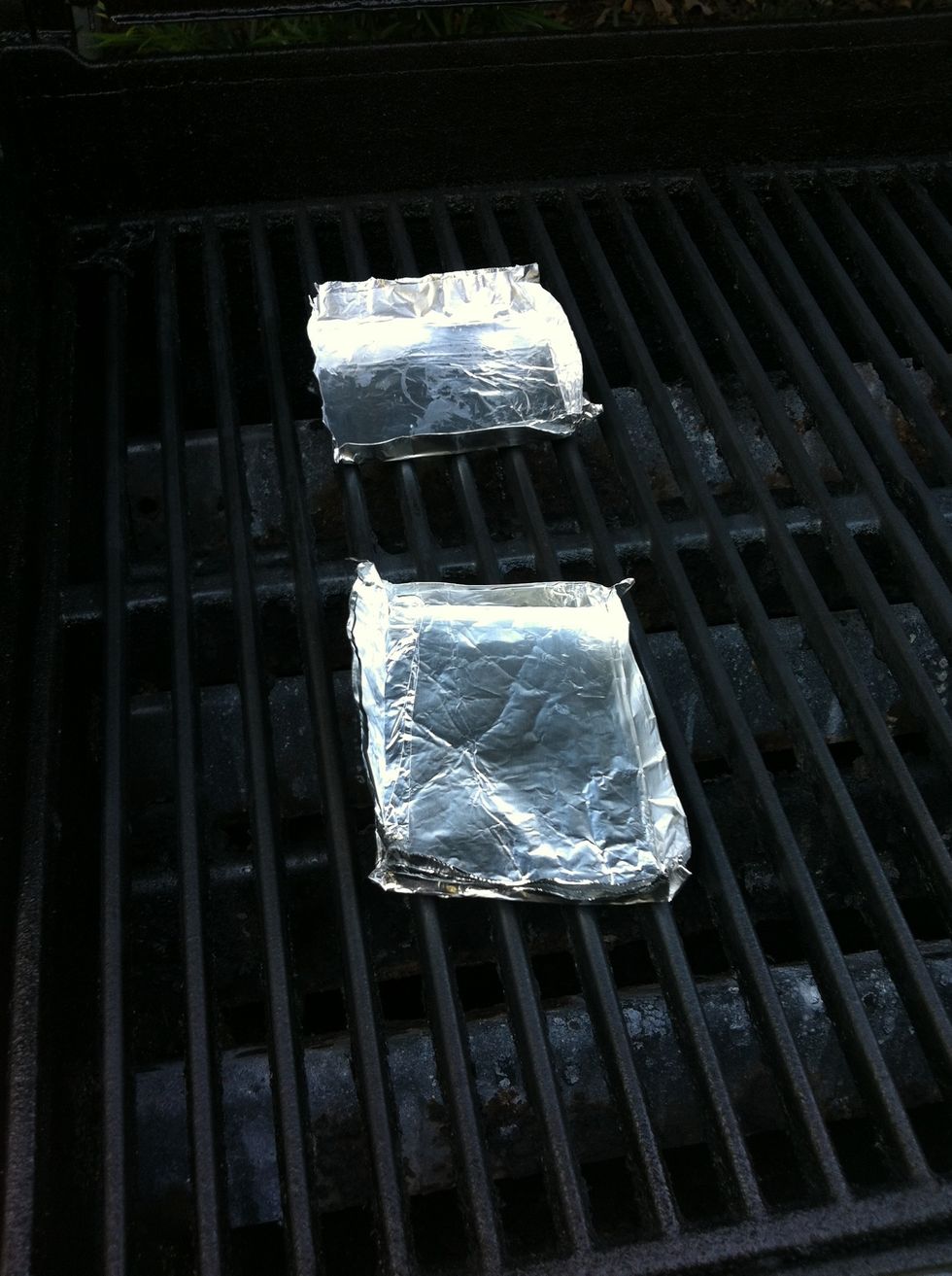 Place prepared foils trays on grill to preheat.