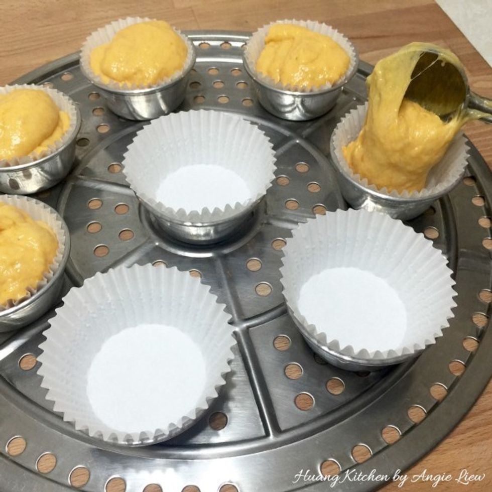 Place pudding cups lined with cupcake liners on a steaming plate. Using an ice-cream scoop, spoon the pumpkin batter into the lined pudding cups till the rim.