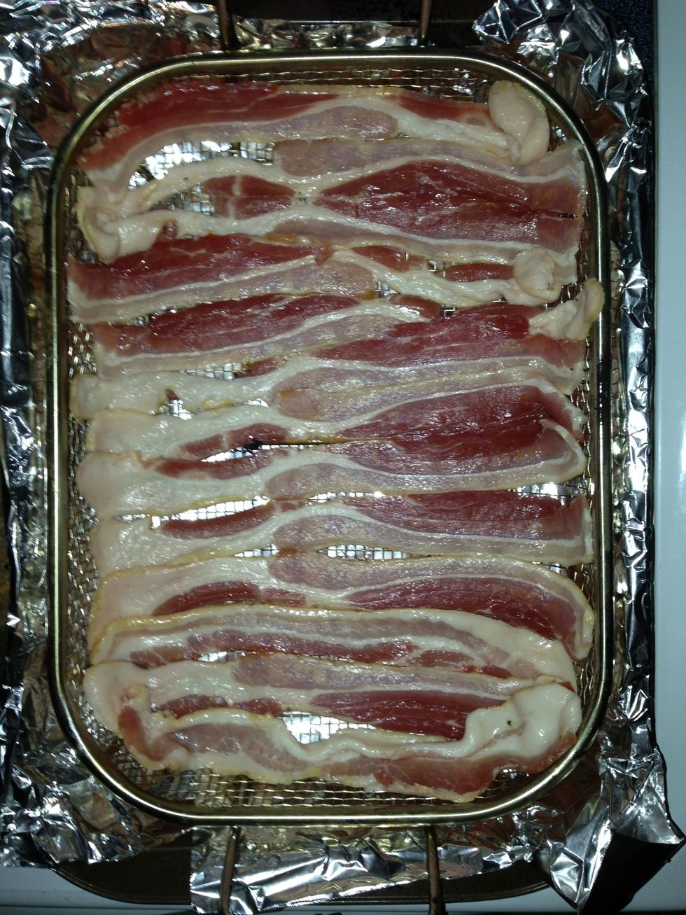 Place rack into a larger baking pan lined with aluminum foil.  This will help keep the bacon grease away from the bacon (this is why I prefer this method).