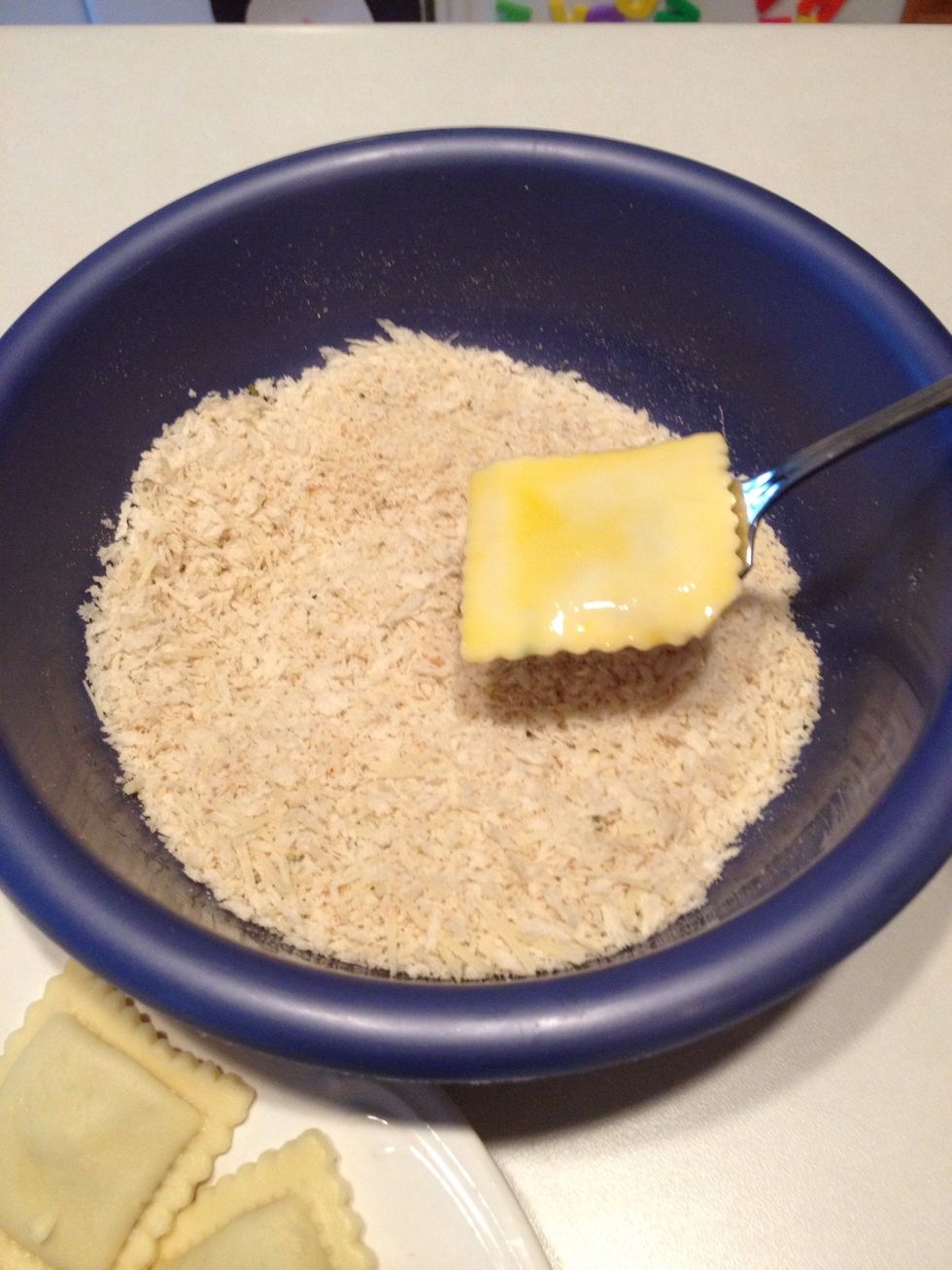 Place ravioli in bread crumbs. Coat well on both sides.