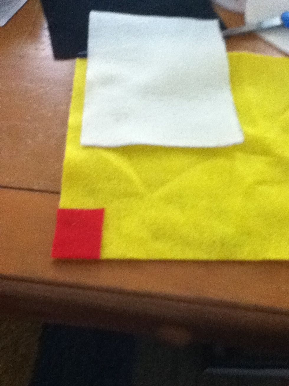 Place red on yellow and cut around. Repeat with both colors until you have enough to fill up the bottom of the flesh colored rectangle.