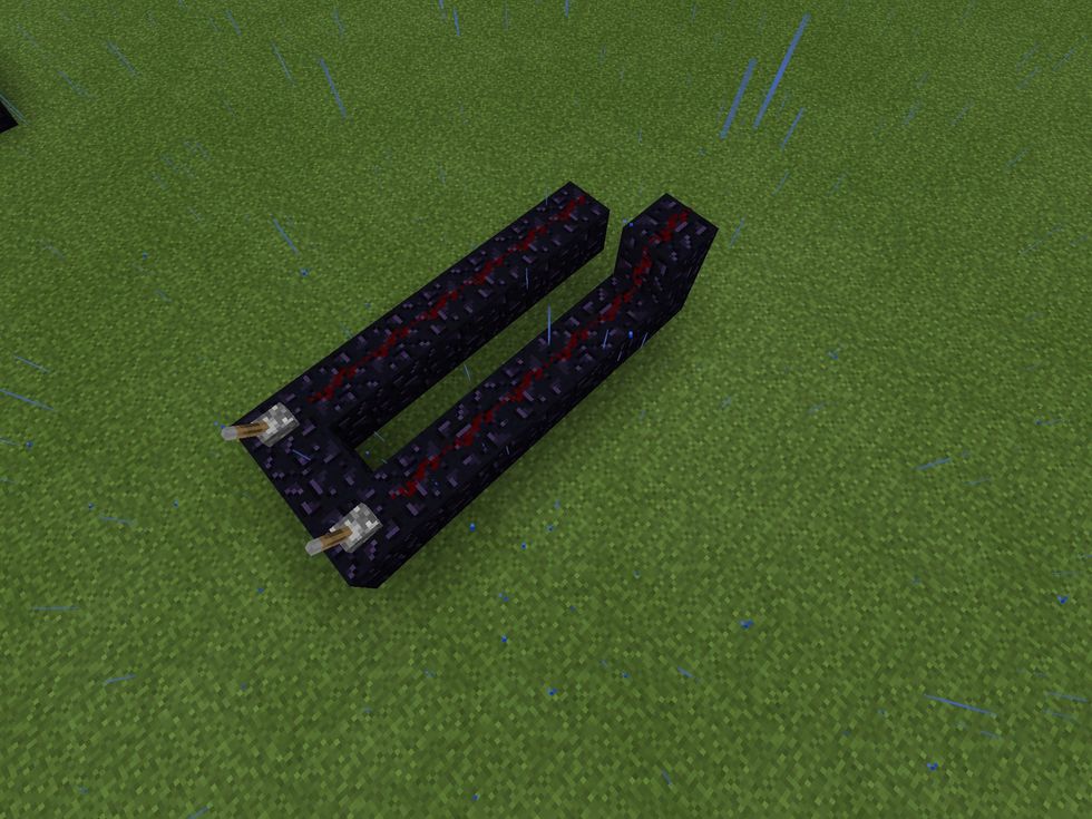 Place redstone dust on all the blocks of obsidian apart from the one between both levers