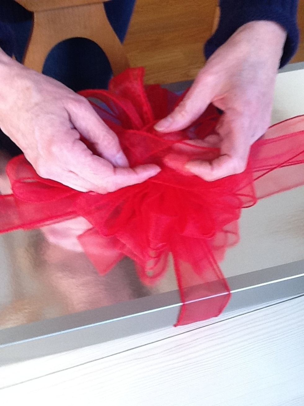 Place ribbon on top of package which has ribbon tied around it