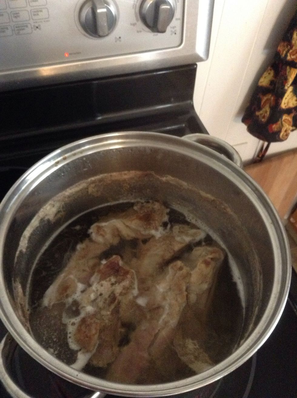 Place ribs in water add salt and cook well. Place both the meat and water in separate bowls and let cool. I usually place the water in freezer for a few minutes to help it along.