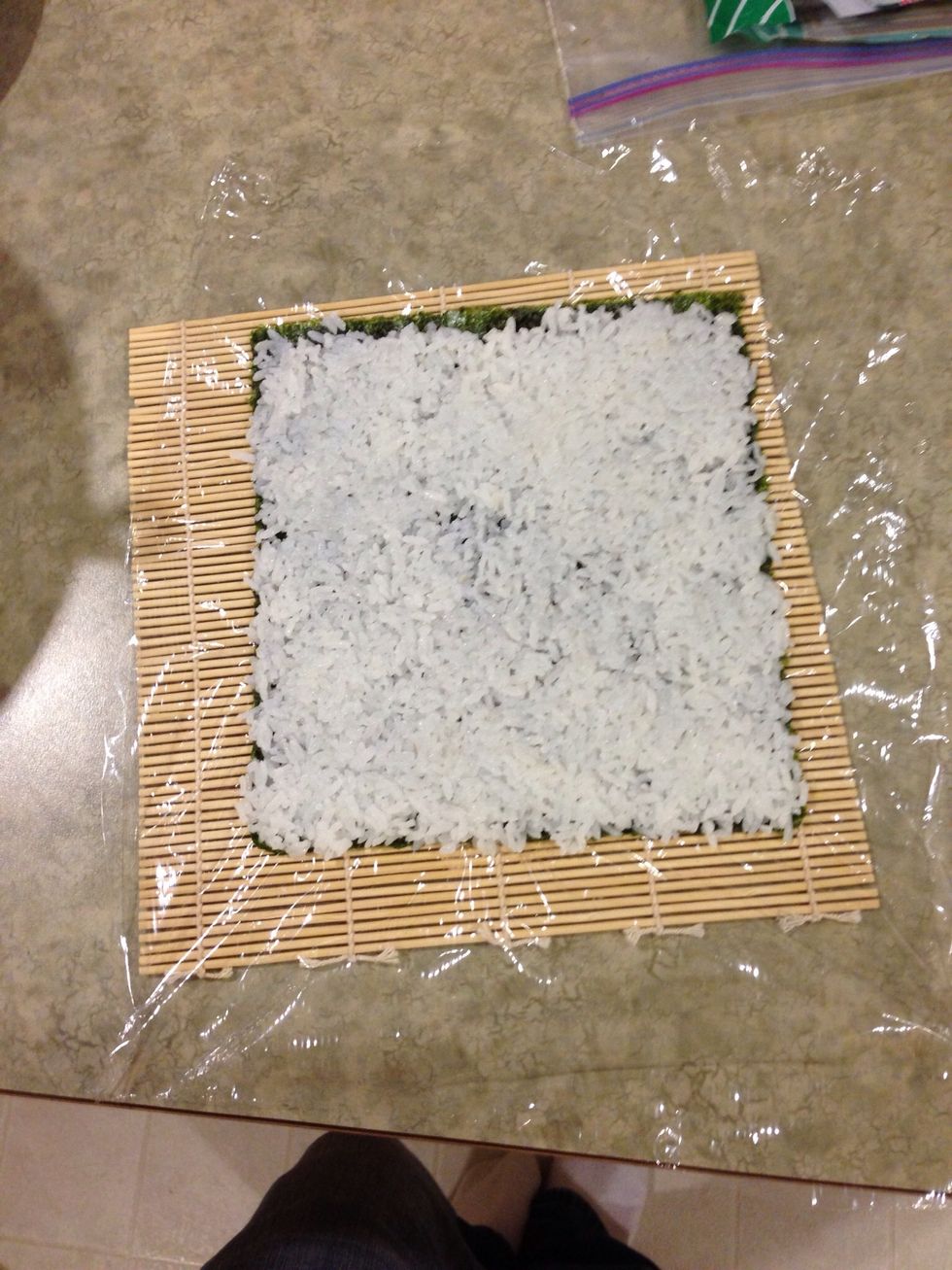 Place rice thin on dry seaweed and flip over on to plastic wrap