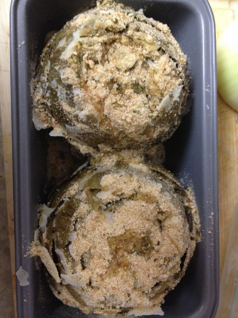 place rightside up in an over safe dish and spread butter, parmesan, and Panko bread crumbs over the top and down the leaves. drizzle with olive oil and bake for 5mins at 350F and broil for 3mins.