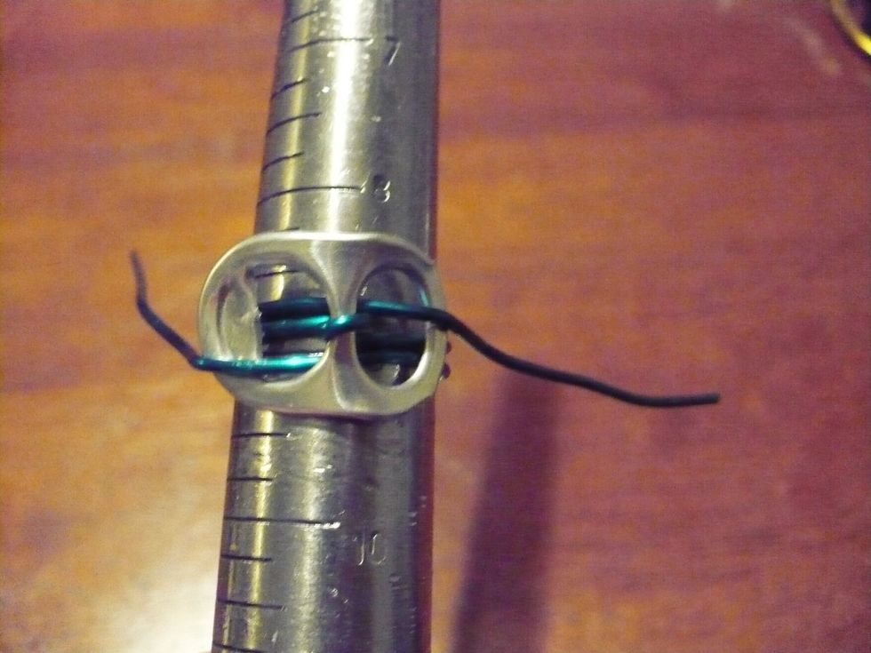 Place ring back on the mandrel and pull tail ends gently. This should reaffirm the circular shape. Note: you should make the ring on a slightly bigger size as the wire wrapping will make it smaller.