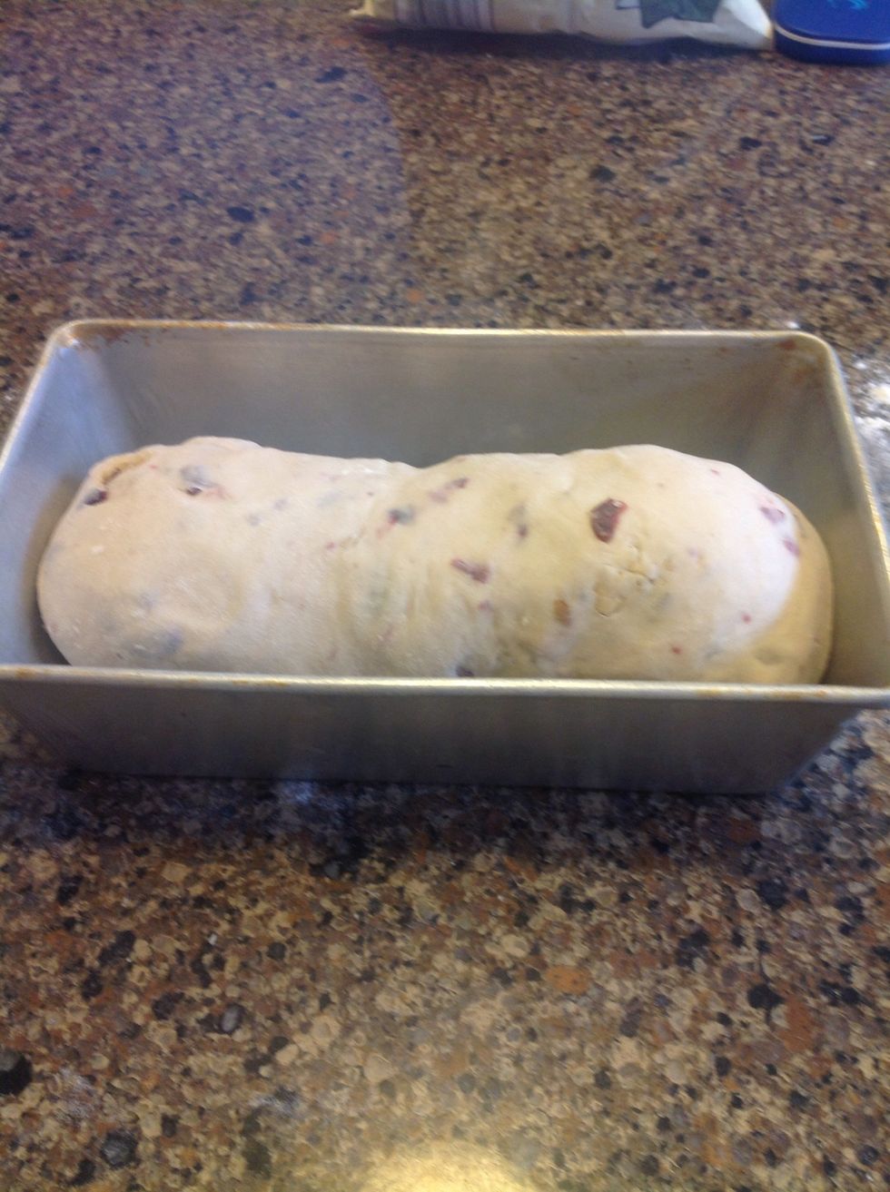 Place rolled and tucked dough in greased pan.