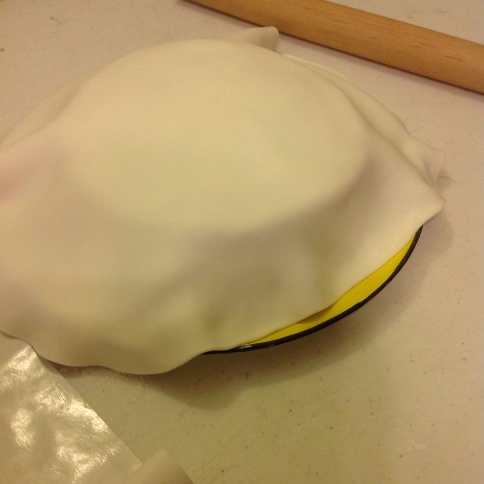 Place rolled fondant onto cakes.
