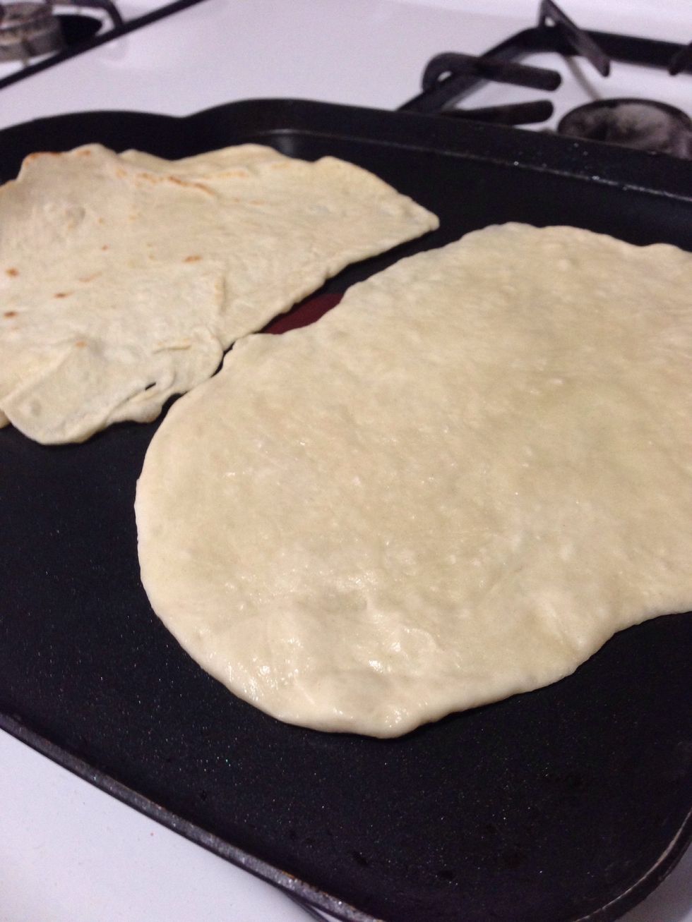 Place rolled tortilla dough on he pan.
