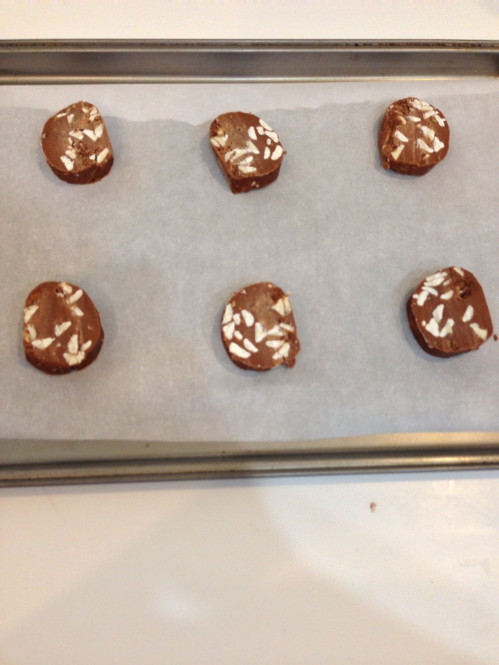 Place rounded tablespoons of dough on ungreased/ parchment paper covered cookie sheet. If you place dough in freezer for about 15 min the cookies will hold their shape better while baking.