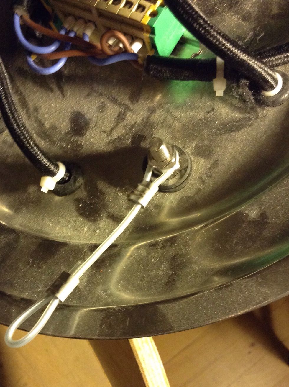 Place rubber rings in the holes for the cords, zip tie the cords in place. Next, fasten the bolts with washers+nuts, add wire with loops then another nut.