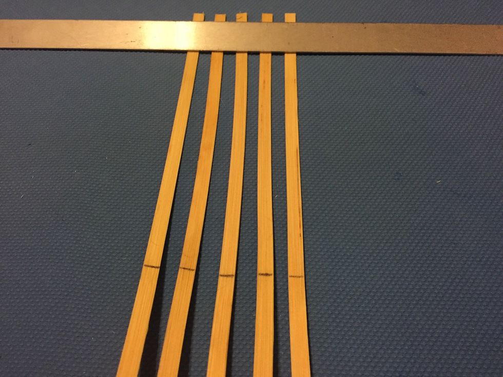 Place ruler at the top of the workspace and evenly space half of your spokes, rough side up. Slide spokes under the ruler (keeps them stable). These are your VERTICAL SPOKES. Line up your middles!