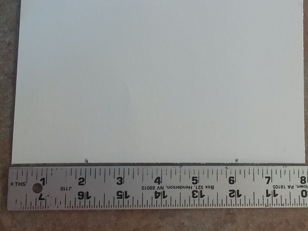 Place ruler at the very bottom of the paper. Make a mark at the 2 inch and 6 inch mark.