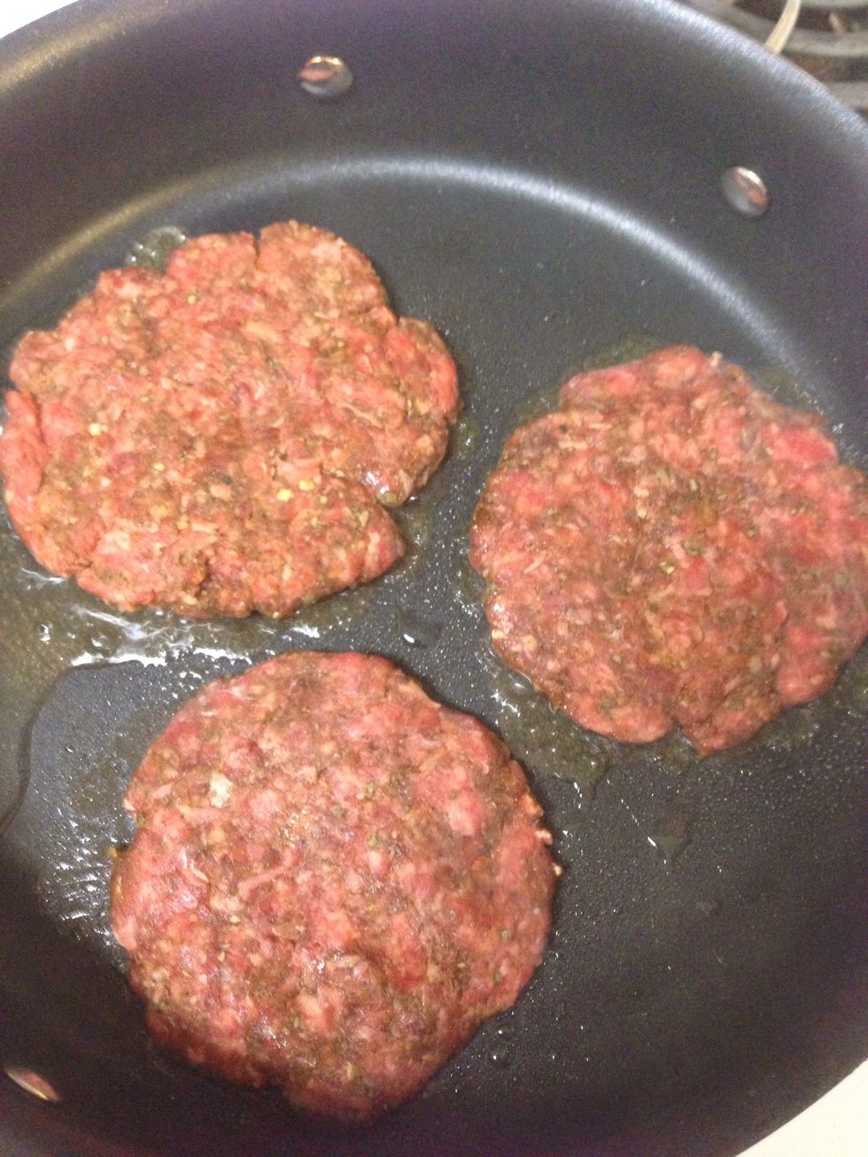 Place sausage patties in a hot skillet and brown on one side.
