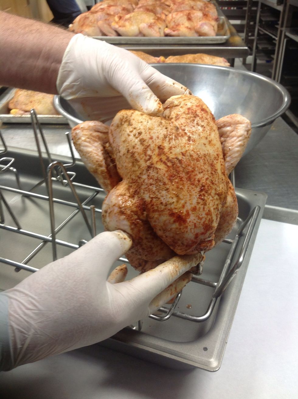 Place seasoned chickens on the Blodgett Rotisserie Roast Rack. Be sure to keep the breast plate open on holder for best airflow.