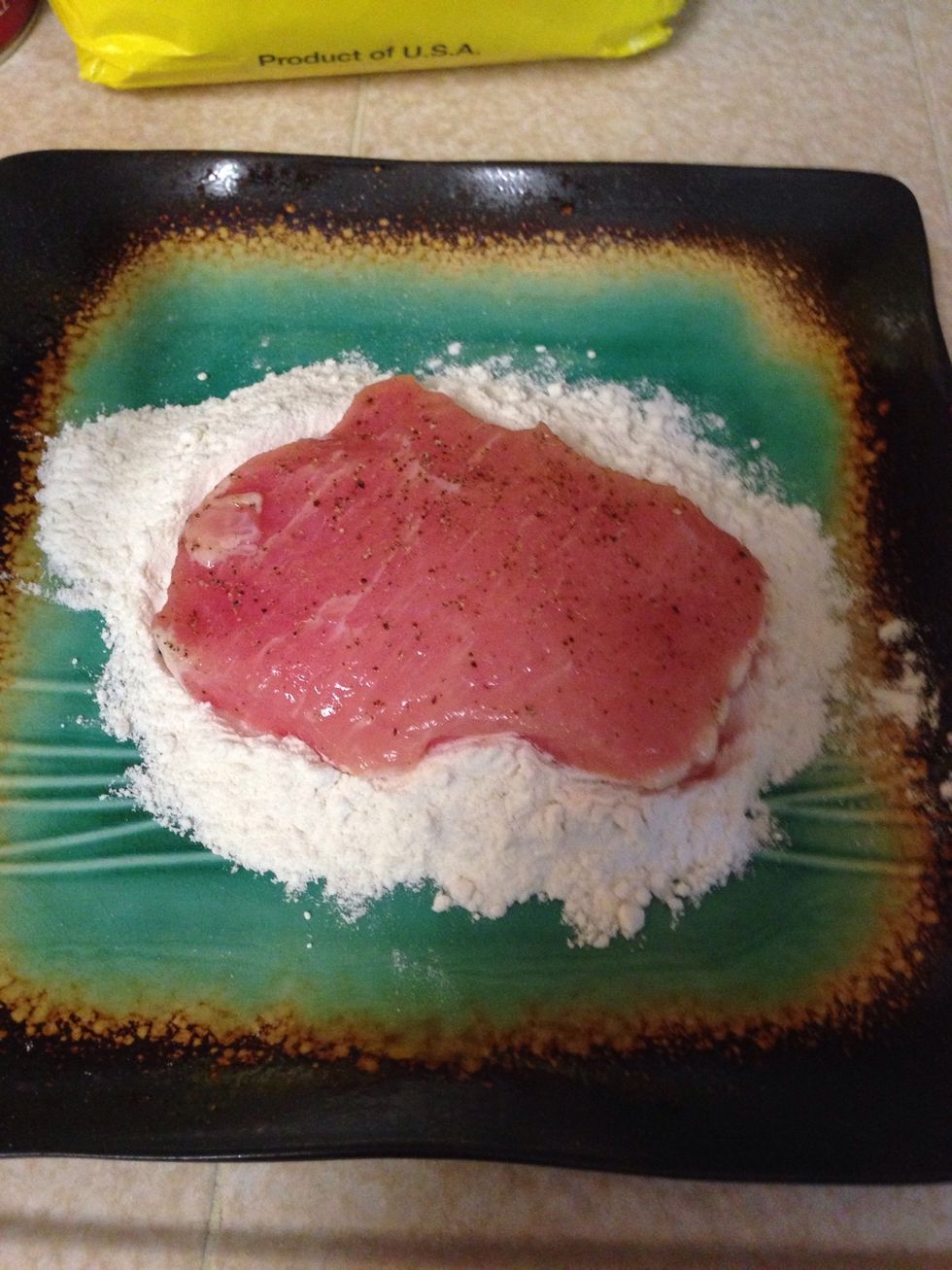 Place seasoned cutlet in flour and coat all sides