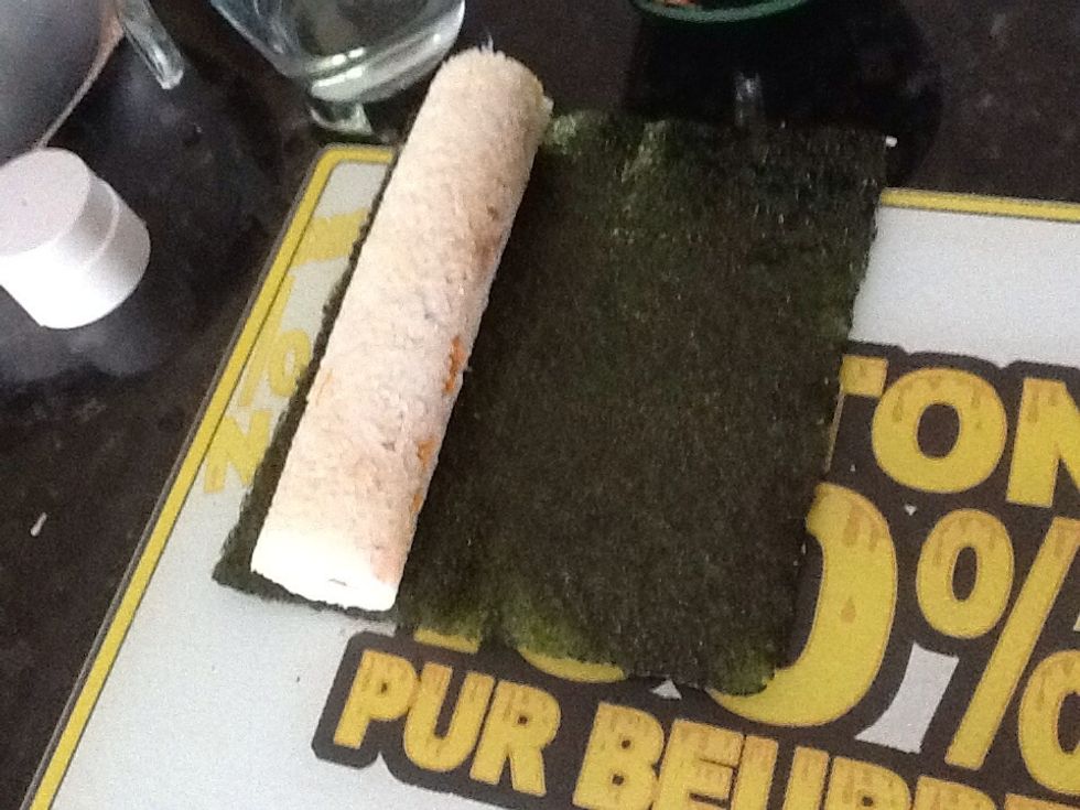 Place seaweed in a board , and Take cap off end and push sushi out with the plunger.