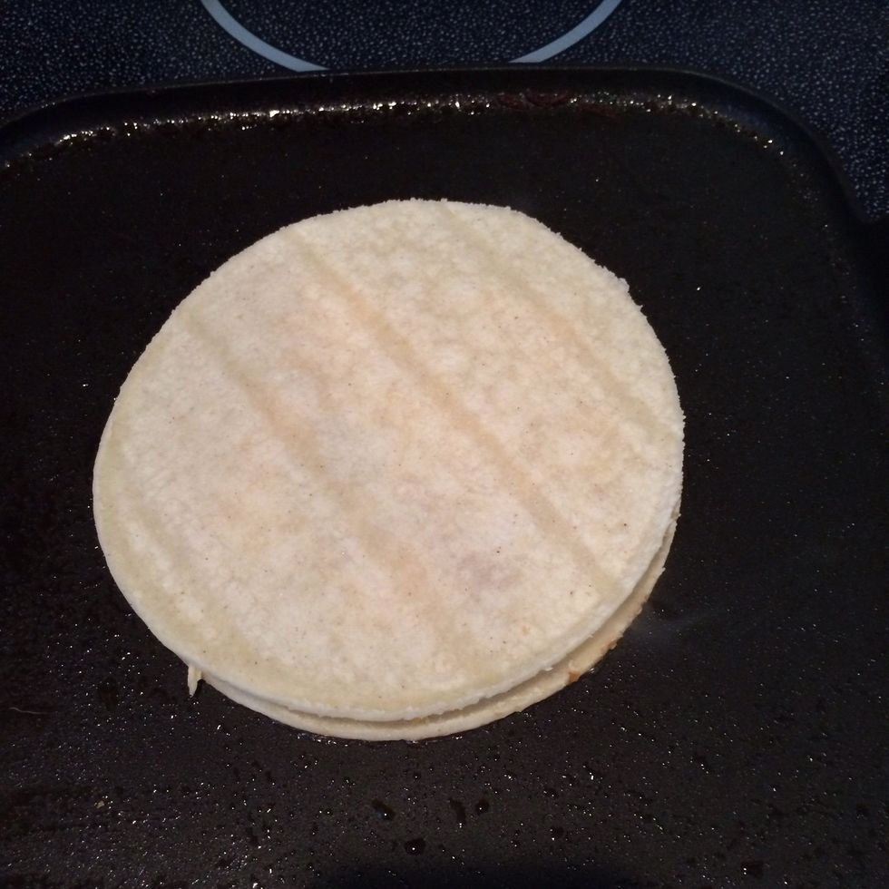 Place second tortilla on top.
