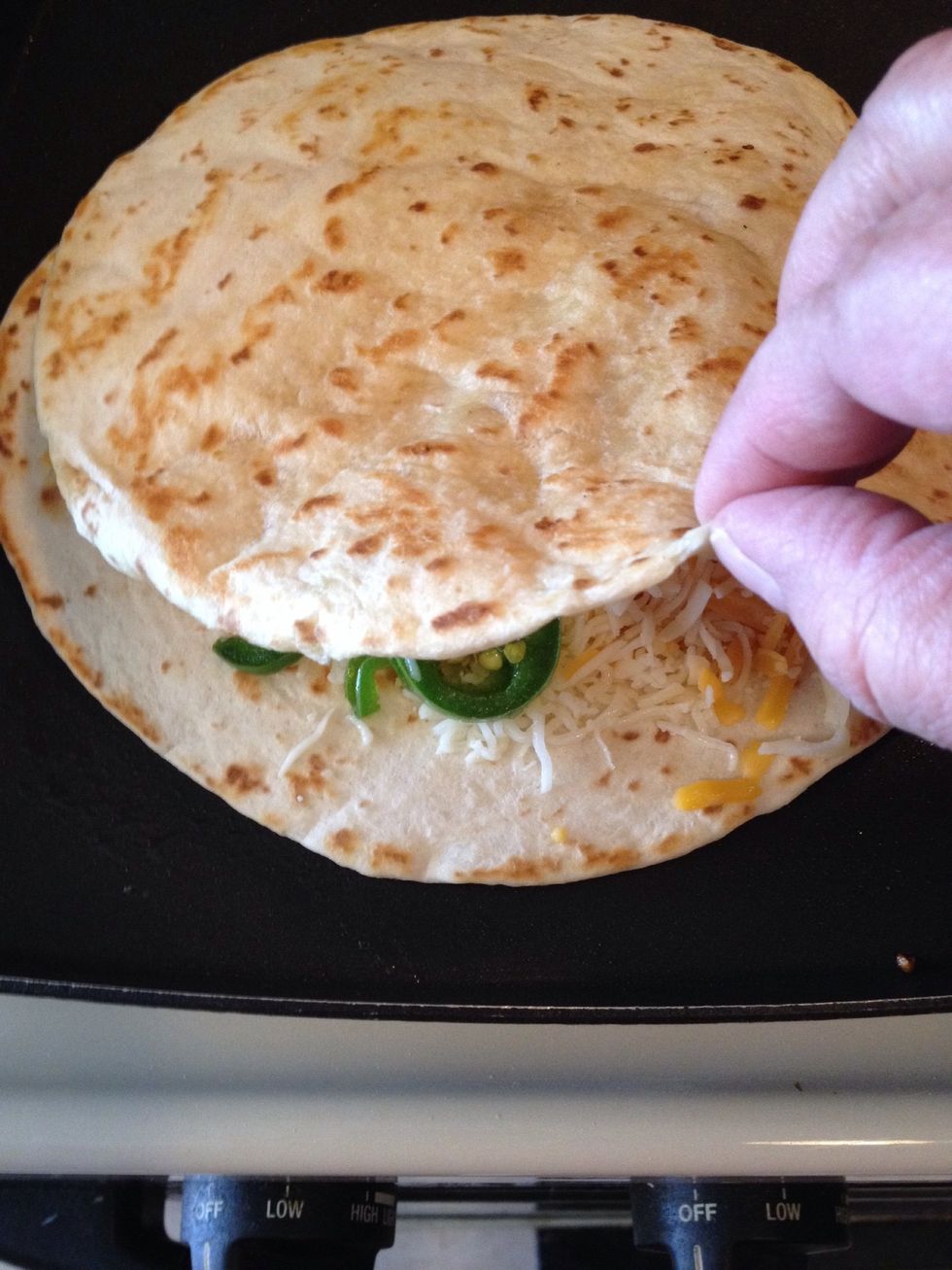 Place second tortilla on top