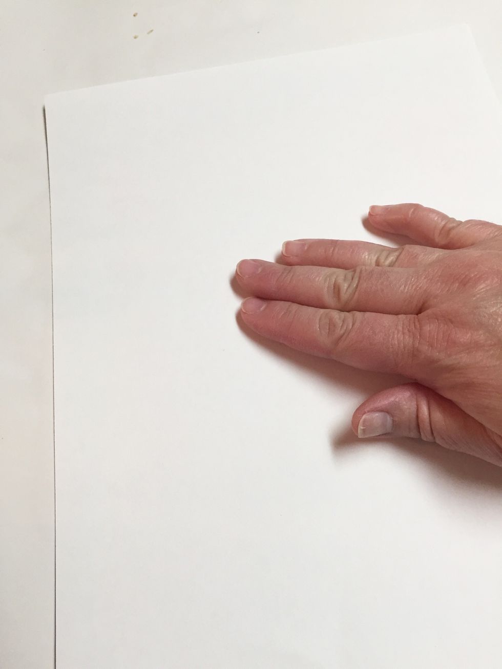 place sheet of paper on top of inked plate and smooth gently with your fingers to transfer ink. be careful not to move paper.