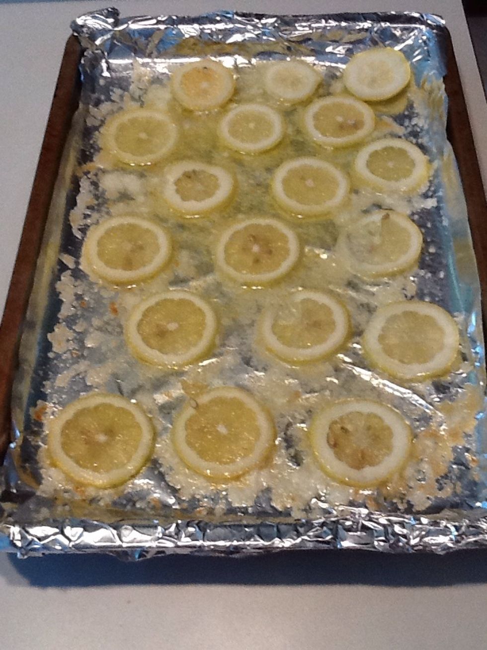 Place sliced lemons on butter.