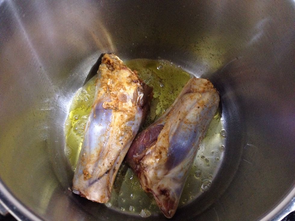 Place some oil, enough to cover bottom surface of pot and about a tablespoon of butter for quick browning. Then, in goes your shanks.