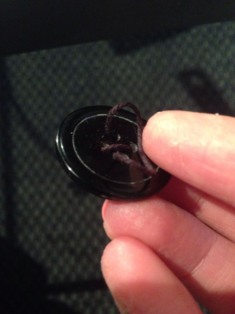 Place some tread in a button that fits the prosthetic piece.