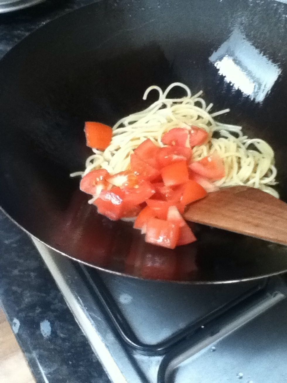 Place Spaghetti into fry pan. Fry with tomatoes. With oil.