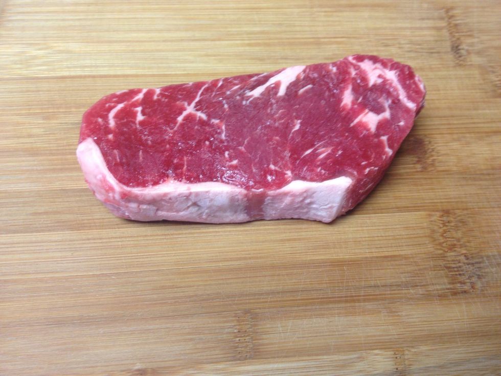 Place steak on chopping block.