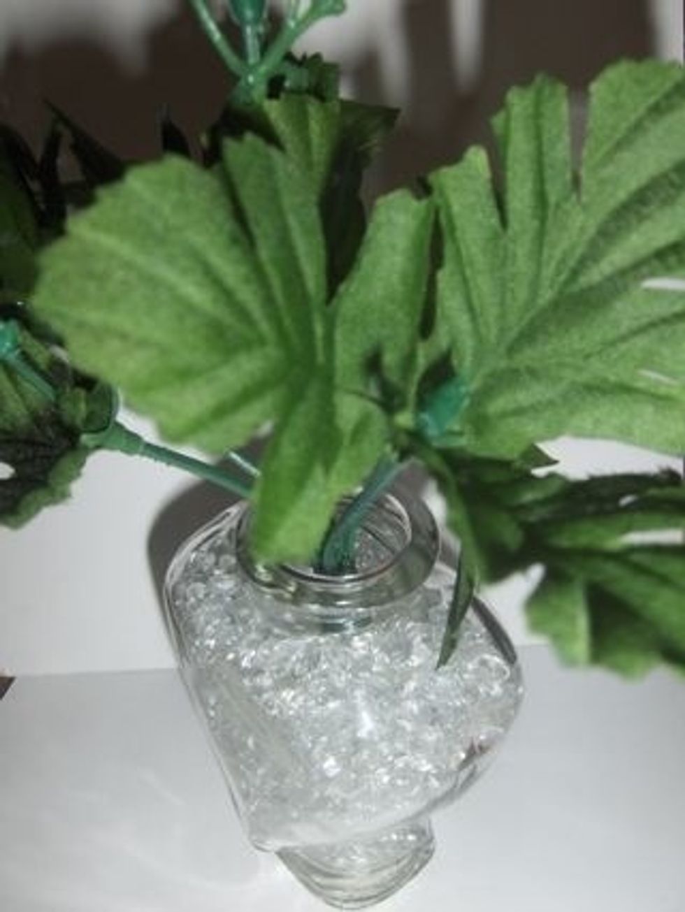 Place stems in vase so that the beads will hold it in place while you attach your flowers.