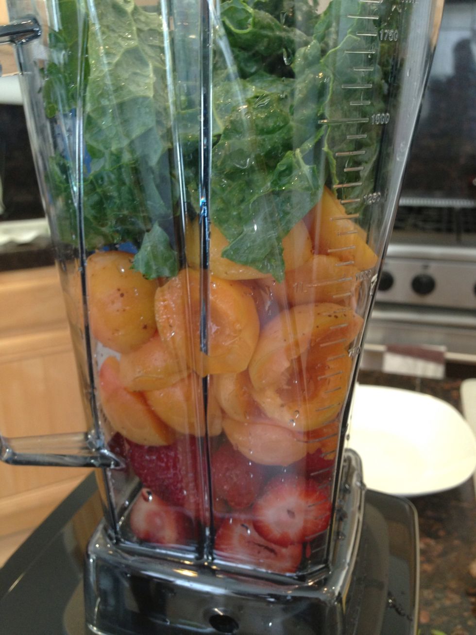 Place strawberries, apricots and kale in the blender.