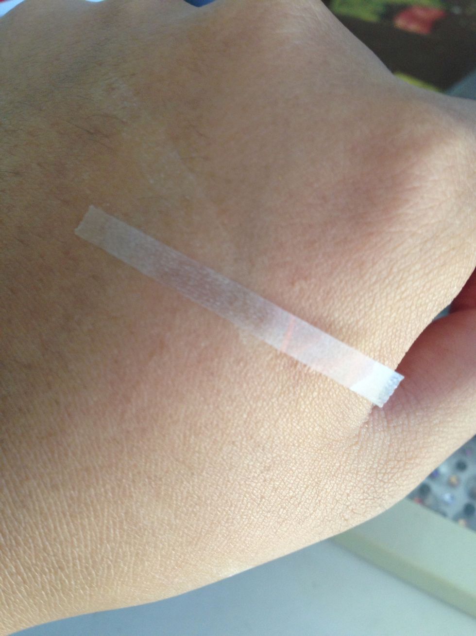 Place strips on your skin. It will pick up the oils and make it less sticky. It's also less likely to pull off nail polish.