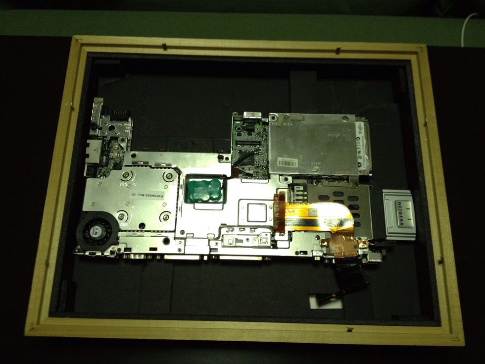 Place system board in frame. Using strips of foam-core to hold system board in place. Strips are glued to the LCD backer board.