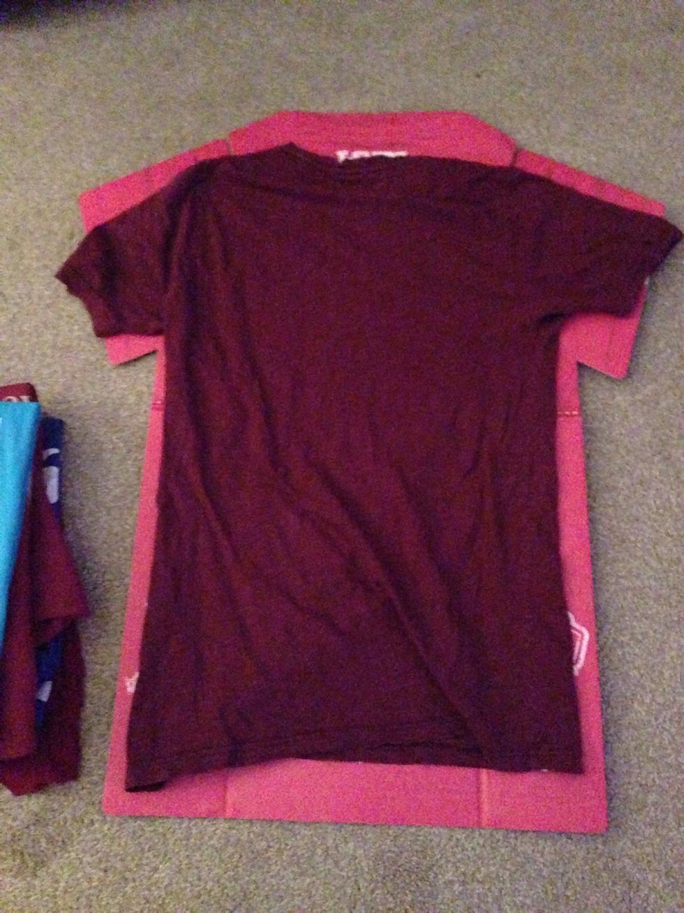 Place t-shirt face first in line with the T-Shirt Folder.