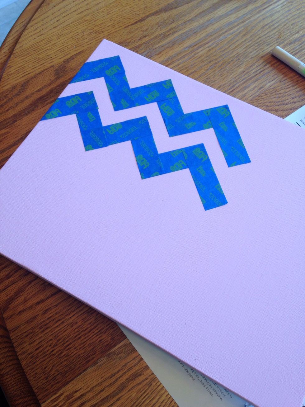 Place tape on canvas on a chevron pattern.  Try to make the space in between the tape consistent.  It can be thick or thin depending on which color you want to "pop" on the canvas.