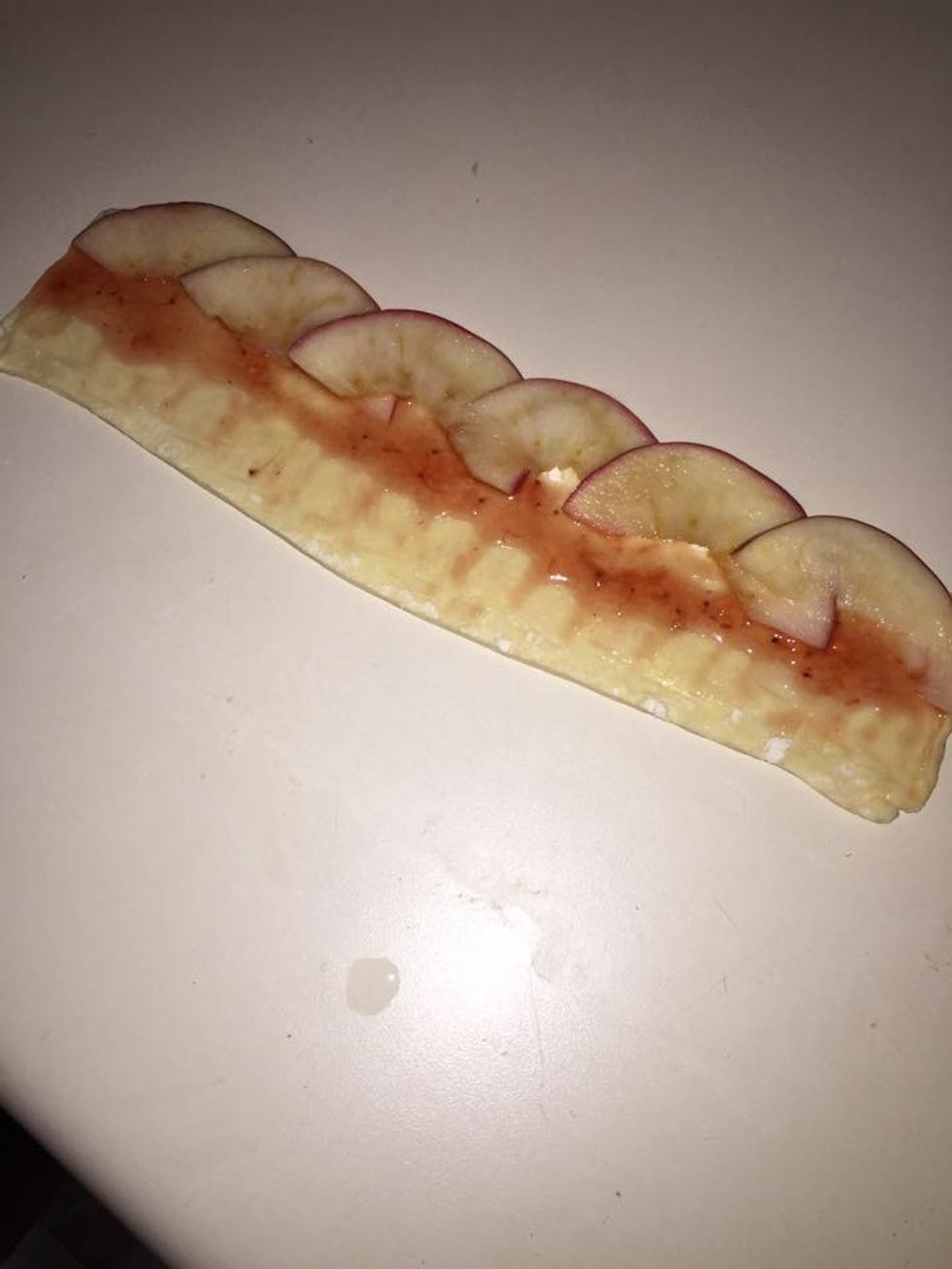 Place the apple slices along the top edge of the strip.