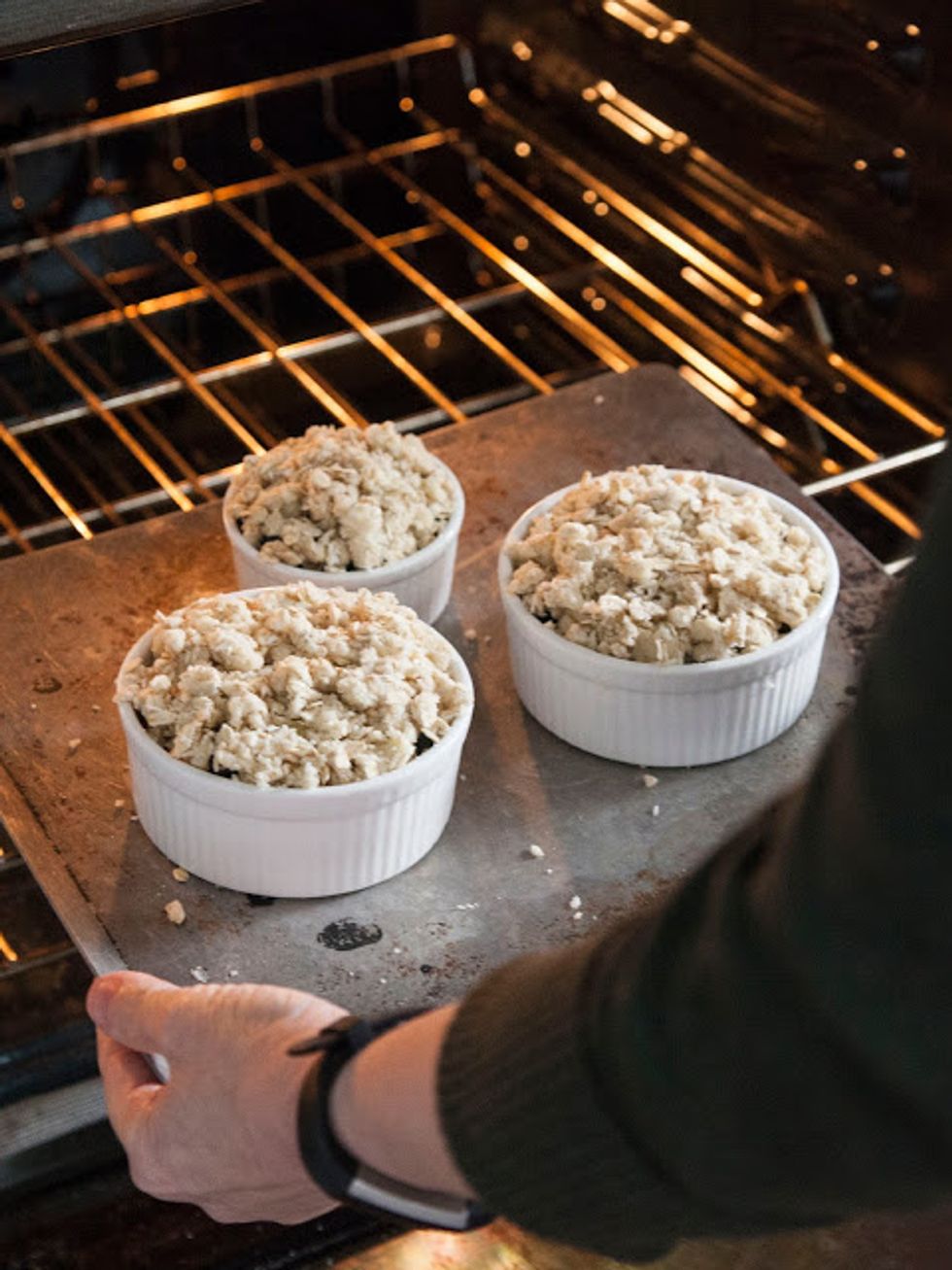Place the baking dish or ramekins on a cookie sheet and place into the middle rack of the oven.