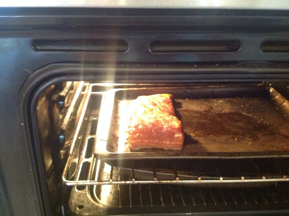 Place the baking tray with the crackling on the top shelf of the oven and turn it up to 225 (your crackling may need more salt rubbed in at this stage)
