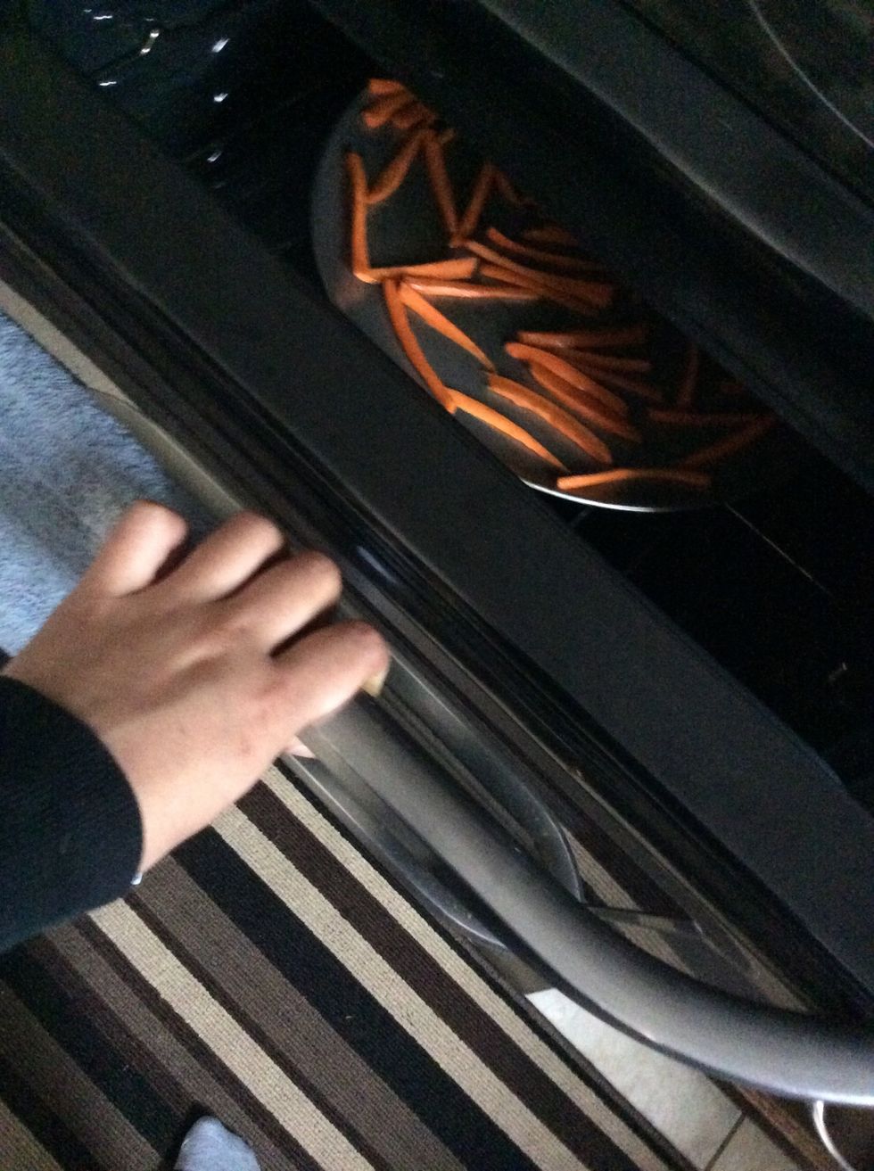 Place the baking tray with your carrot strips. NOTE: Make sure they are not overlapping. Check every five minutes to flip them over and continue this for 20-30 minutes.