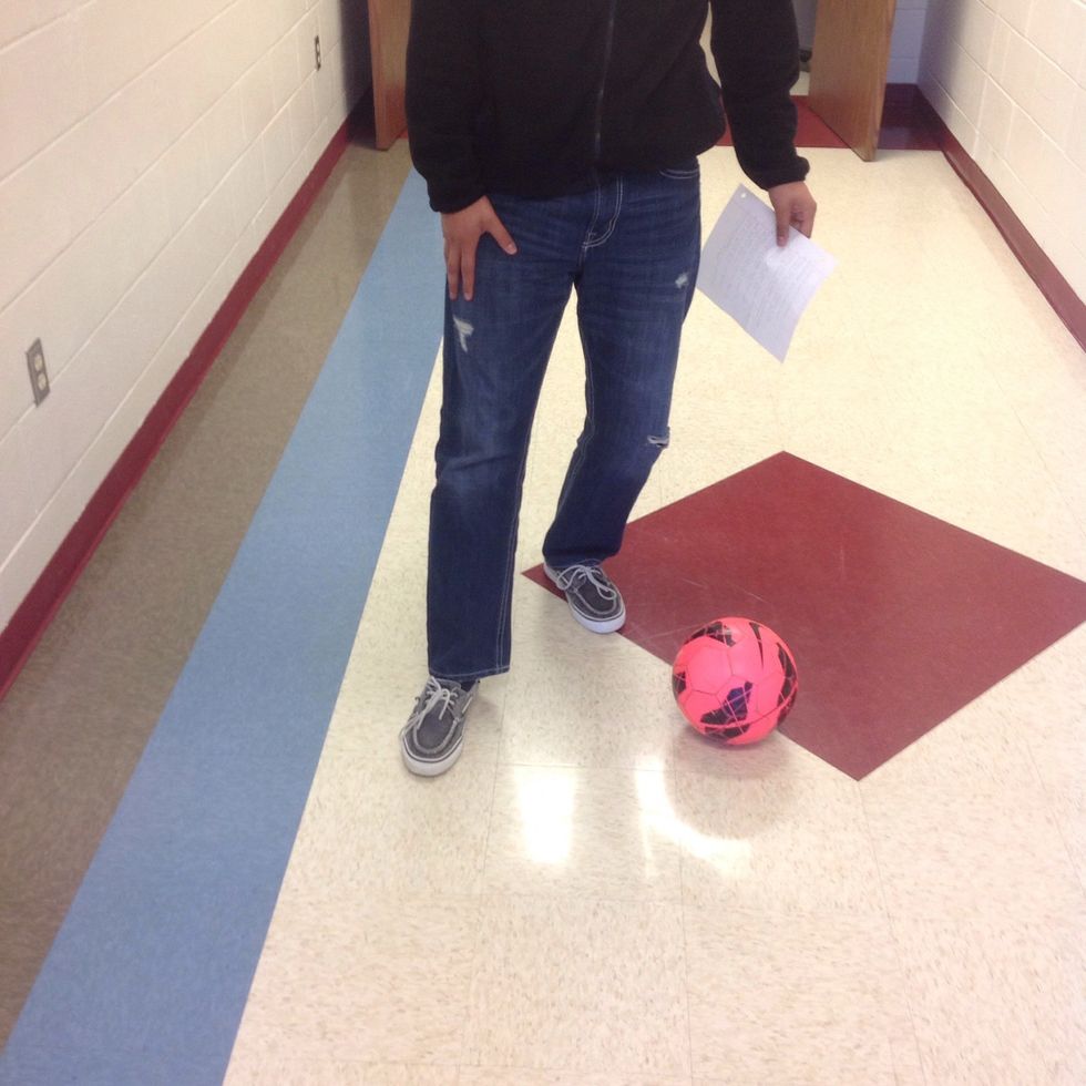 Place the ball slightly to the right or left of both your feet