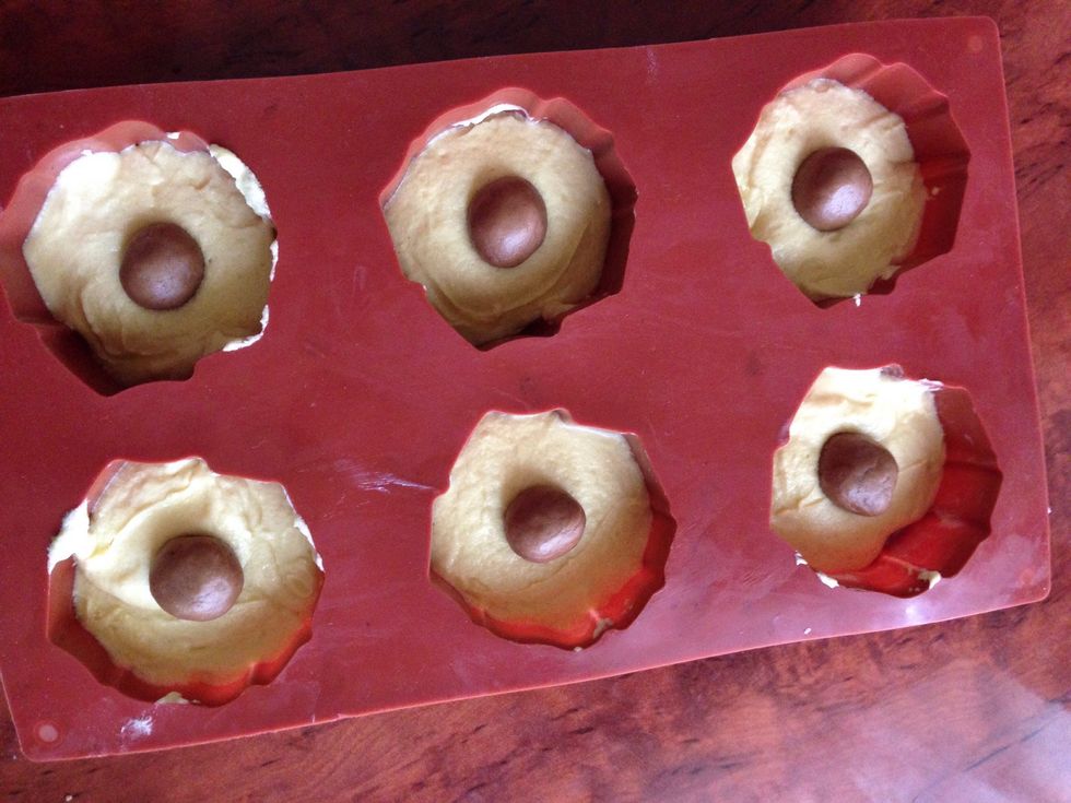 Place the balls in the middle of each cupcake