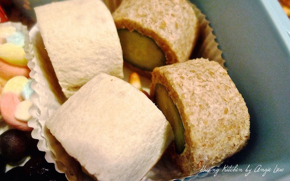 Place the banana and cucumber sushi rolls on a cupcake liner at one corner of the lunchbox.