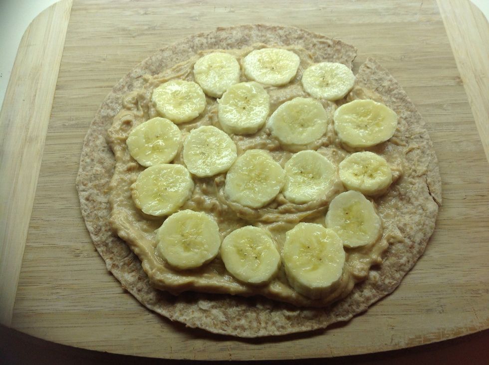 Place the banana slices on top of the peanut butter mixture. This is where you can sprinkle some cinnamon on top of the banana if you like.