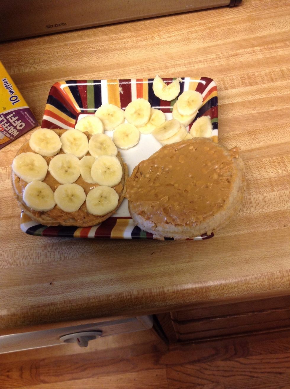 Place the banana slices over the peanut butter