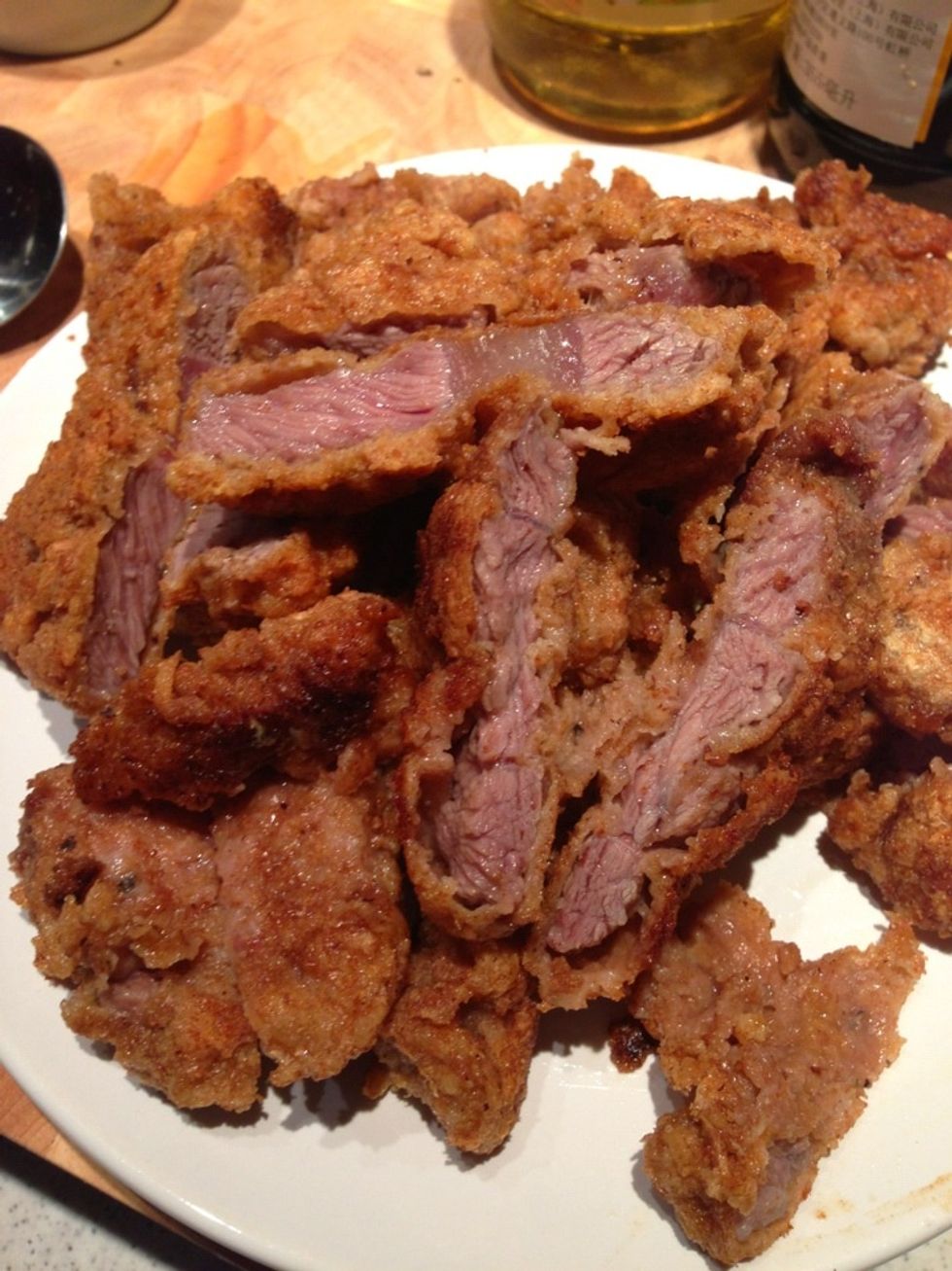 Place the beef cutlets into a plate and cut them into halves. Set aside.